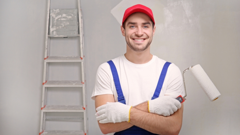 professional painter holding a paint roller for rendering