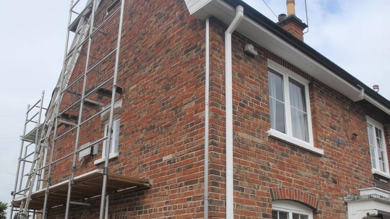 Careful render removal revealing original brickwork beneath, showing skilled render removal work that protects wall structure and long term building health