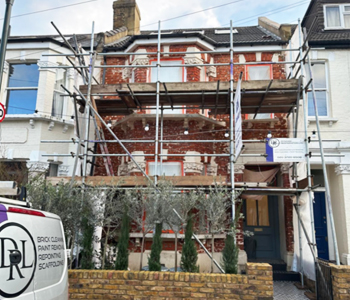 Brickwork paint removal and mortar rake out work in progress