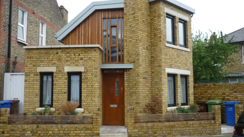 Professional paint removal service removing paint from brick wall in London